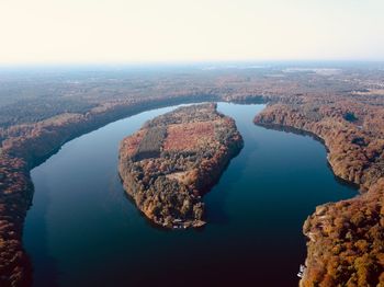 High angle view of rock formation in sea against sky