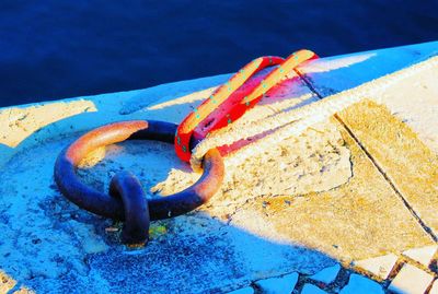 High angle view of rope tied on metal