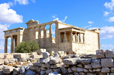 Low angle view of old ruin building against cloudy sky