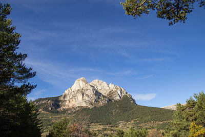 Scenic view of mountains against blue sky