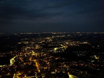 Aerial view of illuminated buildings in city at night
