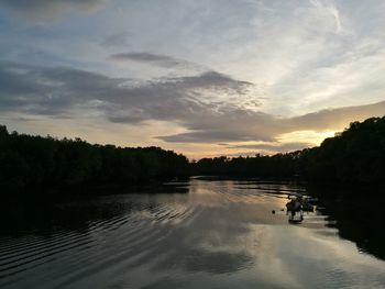 View of calm lake against cloudy sky