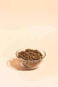 Close-up of food in bowl against pink background