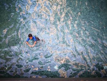 High angle view of man swimming in sea