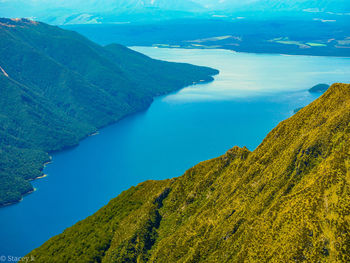 High angle view of sea and mountains against sky