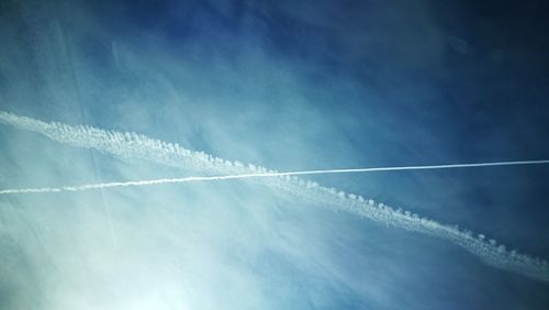 Low angle view of vapor trail in blue sky