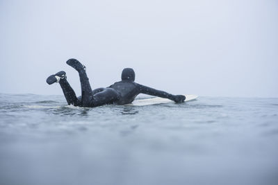 Woman surfing during winter snow