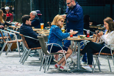 People sitting at sidewalk cafe