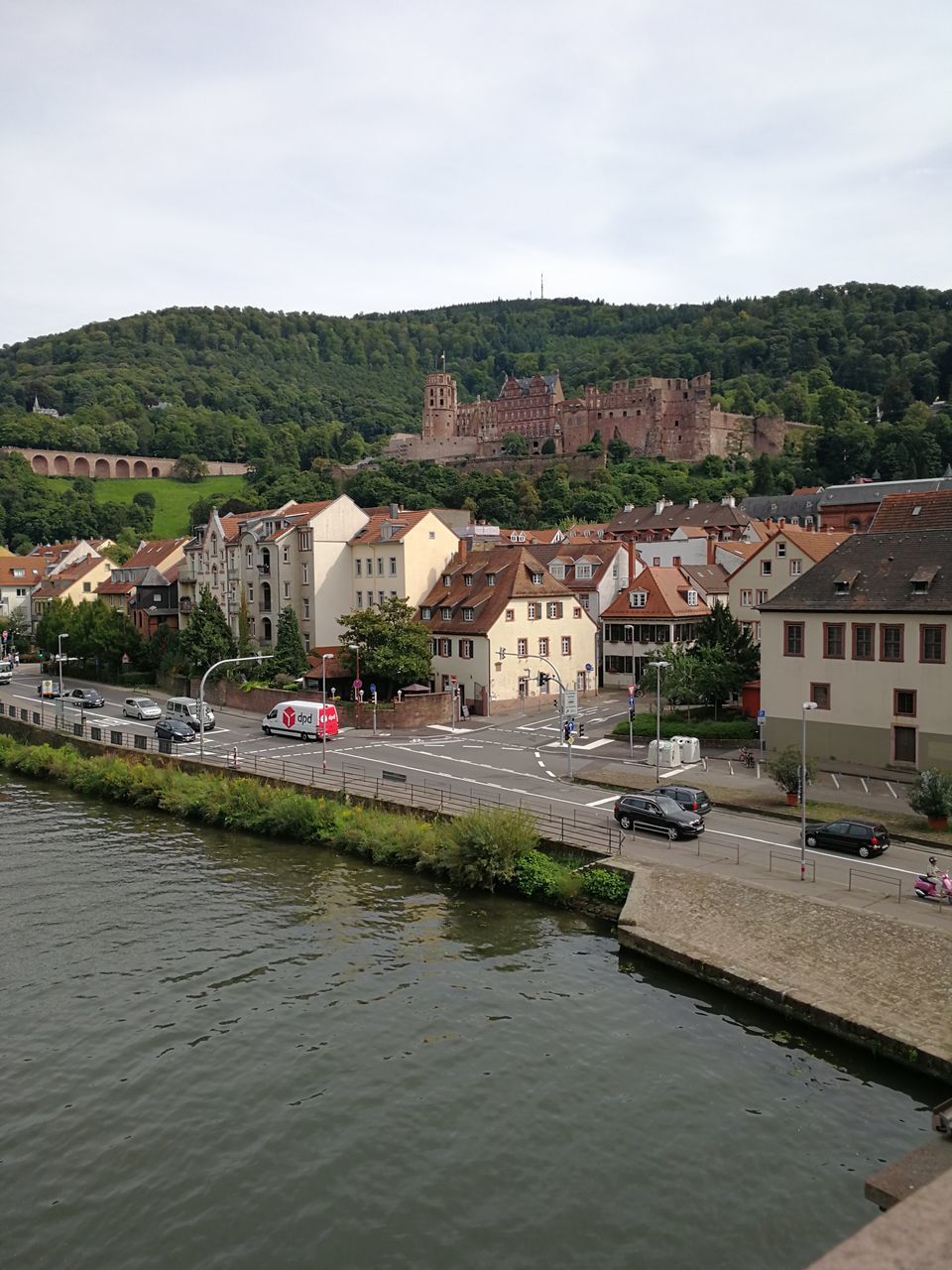 HOUSES BY RIVER AGAINST BUILDINGS IN TOWN