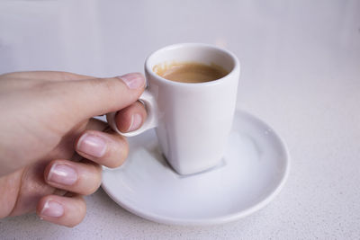 Midsection of woman holding coffee cup