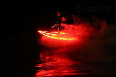 Close-up of illuminated red water at night