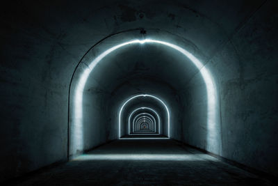 Empty corridor in illuminated building