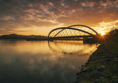 View of bridge over river against sky during sunset