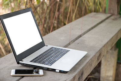 Close-up of laptop and smart phone on table