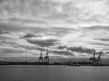 Commercial dock by sea against sky