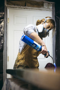 Female resin artist using blowtorch to finish artwork