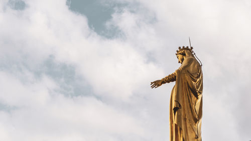 Low angle view of statue against sky