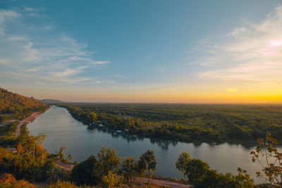 Scenic view of river against sky during sunset