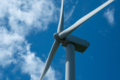 Low angle view of windmill against blue sky