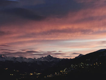 Scenic view of silhouette mountains against dramatic sky