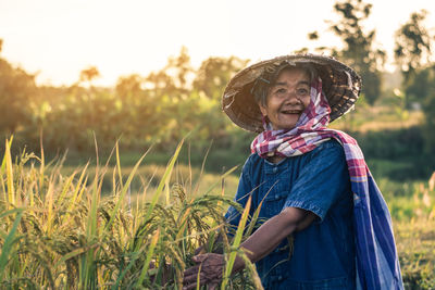 Senior woman wearing hat working in farm