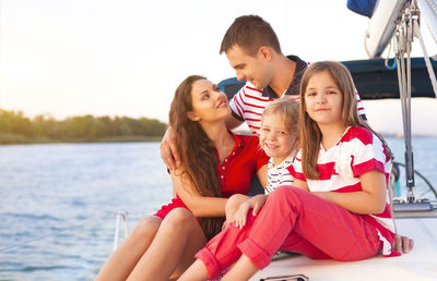 Happy family on boat during vacation
