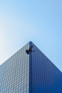 Low angle view of modern building against clear blue sky