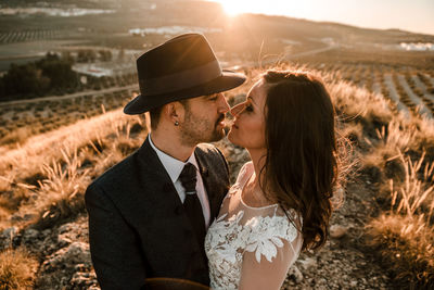 A young couple in a wedding dress with a sunset in the background. wedding concept