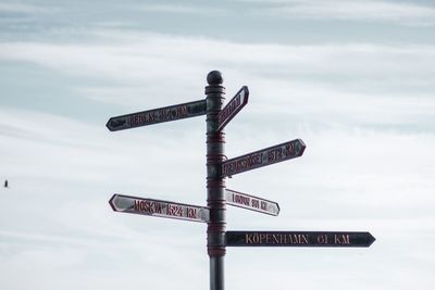 Low angle view of road signs against sky