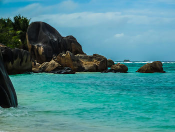 Panoramic shot of rocks in sea against sky