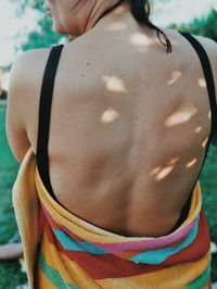 Rear view of woman in bikini standing outdoors