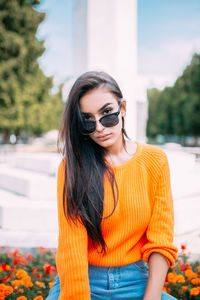 Beautiful young woman wearing sunglasses standing outdoors