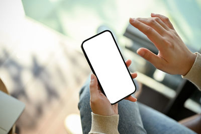 Midsection of woman using mobile phone