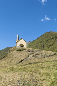 Church on hill against blue sky