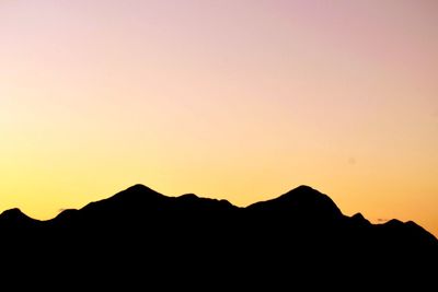 Silhouette mountains against clear sky