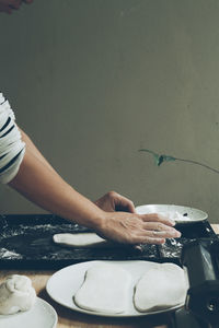 Cropped hand of man working on table