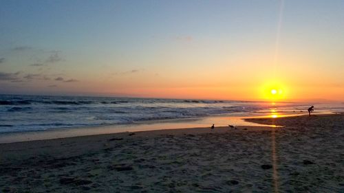 Scenic view of beach against sky during sunset