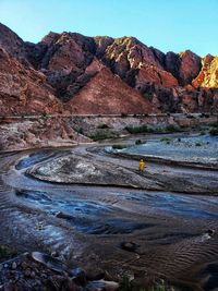 Scenic view of river and mountains against sky