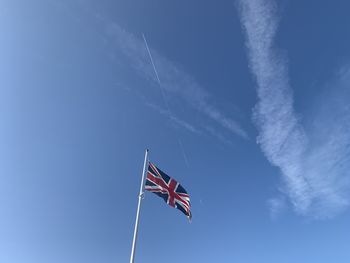 Low angle view of crane against blue sky