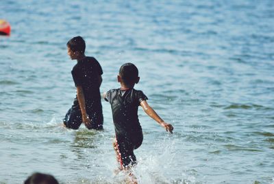 Full length of children on sea shore