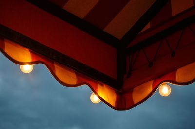 Low angle view of illuminated bridge against sky at night