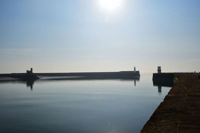 Silhouette pier over sea against sky