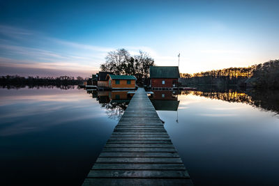 Pier over lake against sky