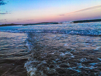 Scenic view of sea against sky at sunset
