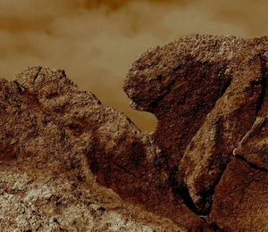 Low angle view of rock formation on land against sky