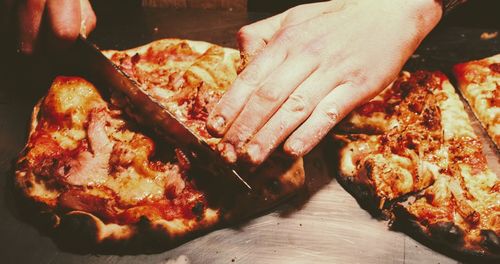 Close-up of man preparing food on barbecue grill