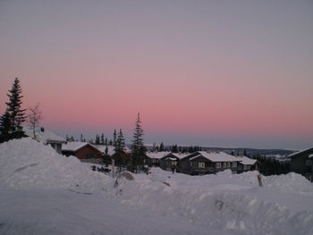 Snow covered landscape at sunset