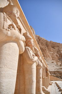 Low angle view of statues against sky