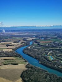 Scenic view of river against clear blue sky