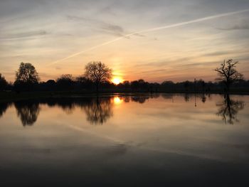 Scenic view of lake against sky during sunset